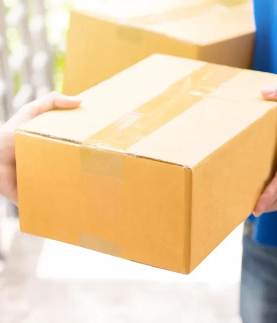 Happy young man accepts a package for his delivery business.