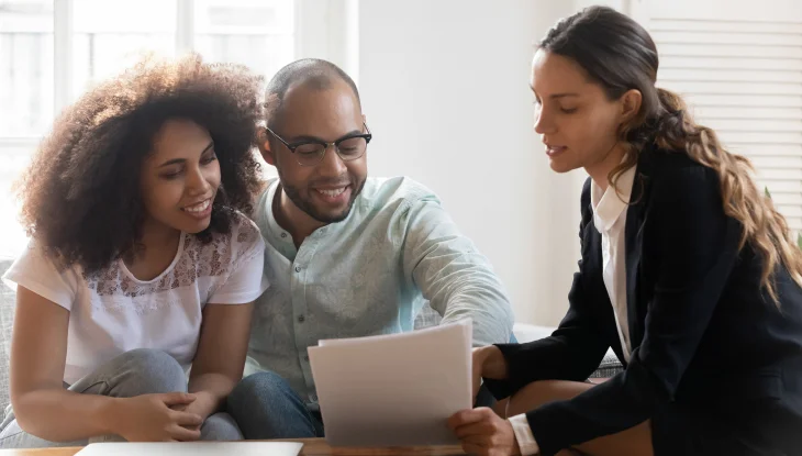 Young couple meeting with insurance agent.