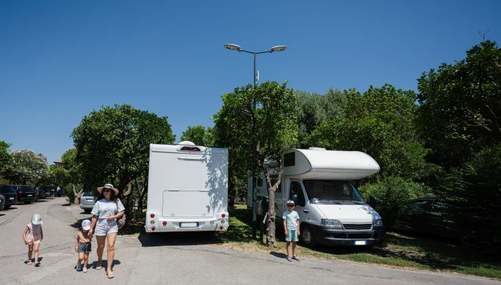 Family walks together at RV park.