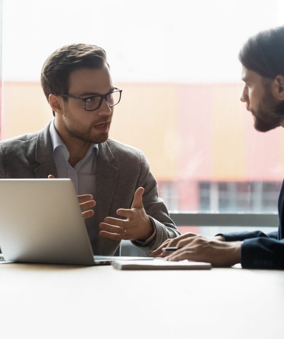 Two business men discussing types of business insurance