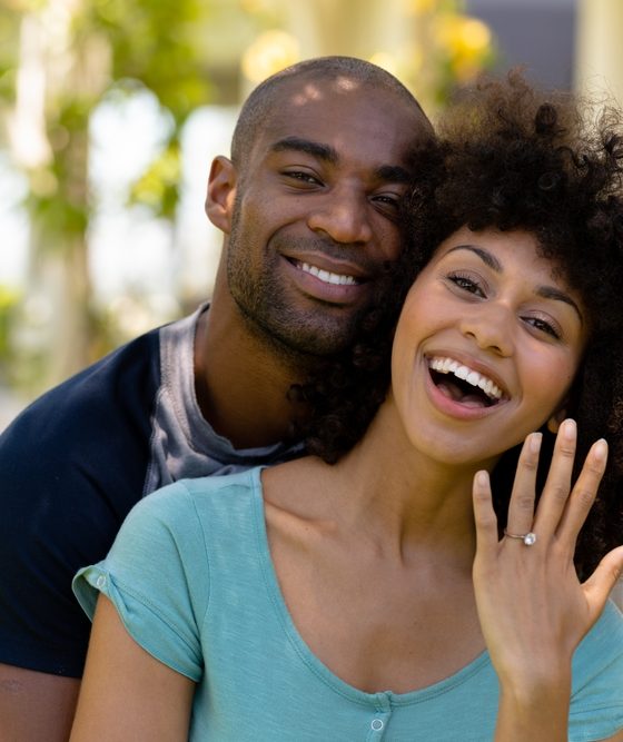 Woman showing the engagement ring that the man has just given her - Velox, cheap auto insurance in Georgia