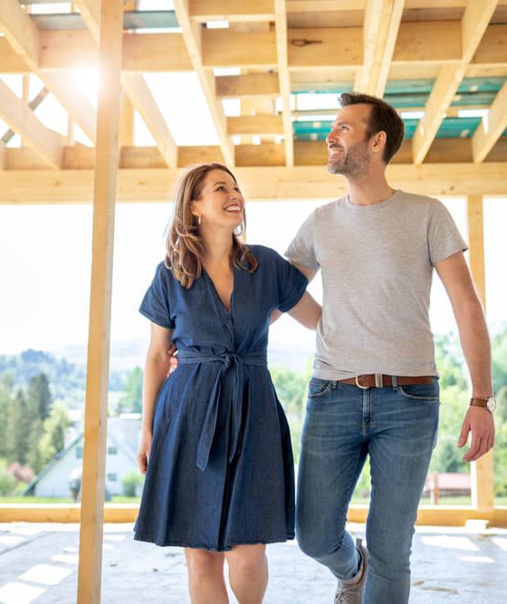 Couple walks through their framed out home.