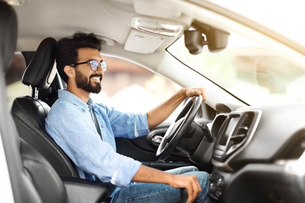 Man driving and holding his car gear