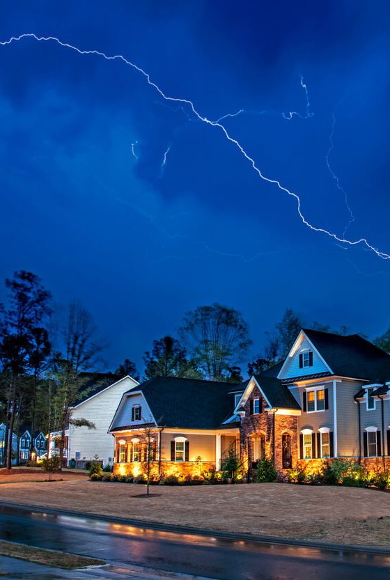 Lightening breaks over homes in Atlanta during a storm - cheap home insurance in Atlanta, Georgia.