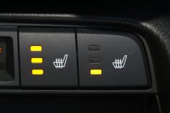 An image shows icons on a car dashboard indicating seat warming technology - cheapest car insurance in Georgia.