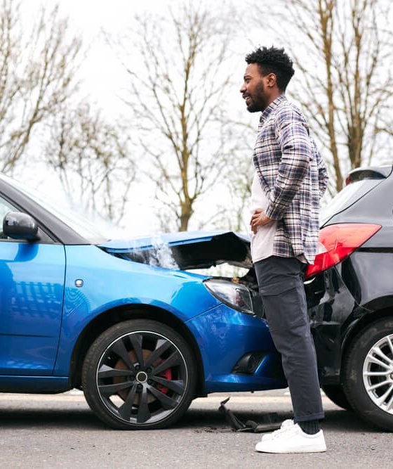Senior and younger male drivers get out of cars and inspect damage after road traffic accident, what to do after a car accident, cheap car insurance in Georgia.