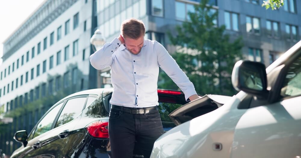 Man suffering from neck pain after car accident. seeking legal aid for compensation for auto injury whiplash, what to do after a car wreck in Georgia.