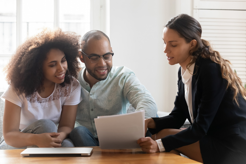 couple looking over renters insurance documents with agents