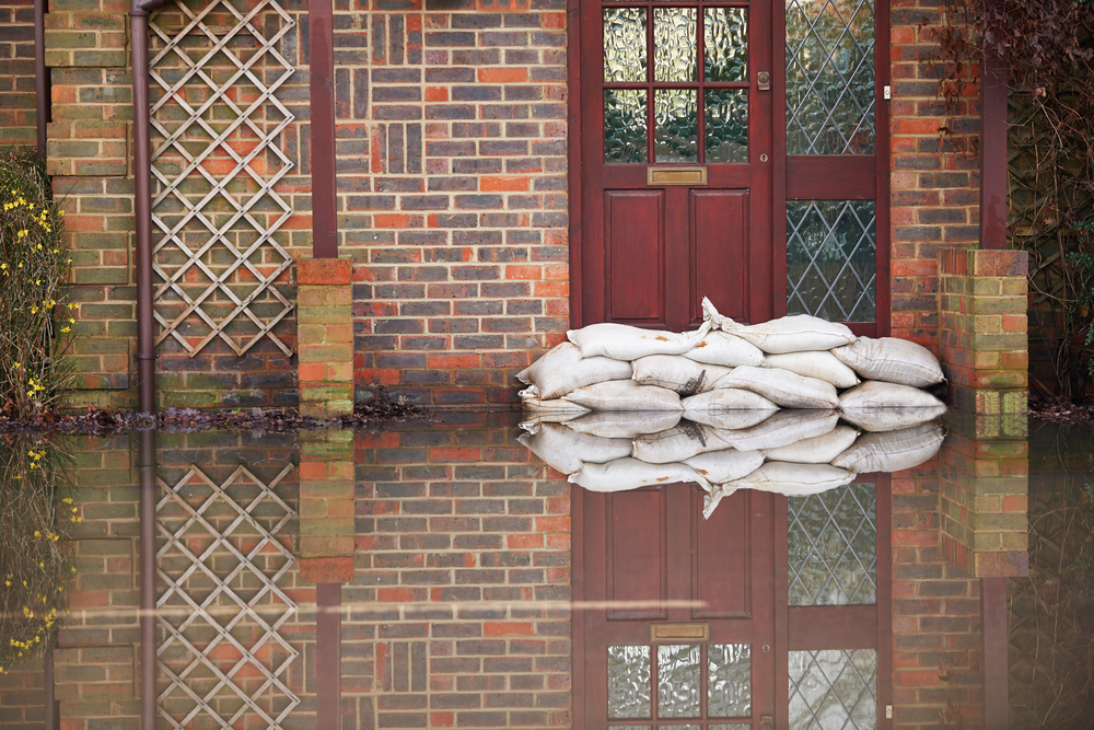 flooded home with sand bags in front of door