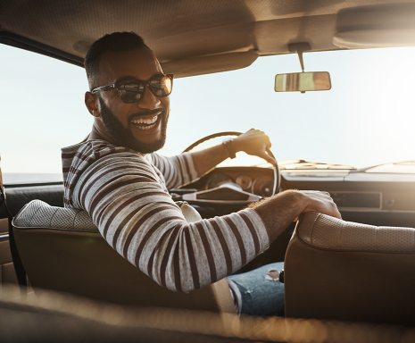 Man smiles while driving