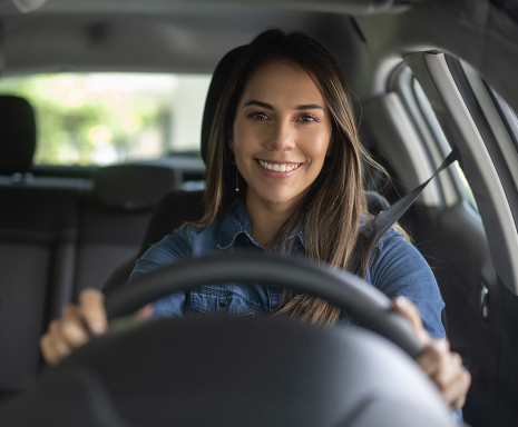 Young woman smiles while driving
