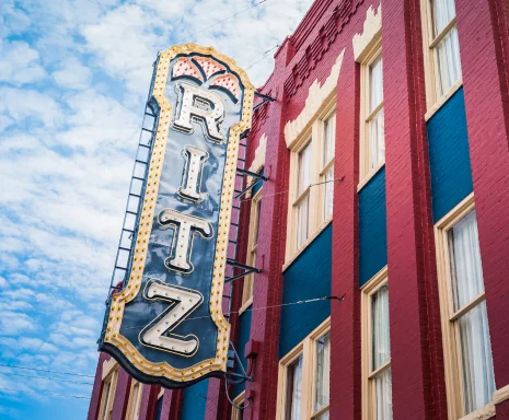 Historic Ritz Theater Sign in Old Town Brunswick on a Red and Blue Brick Facade: Cheap car insurance in Brunswick, Georgia.