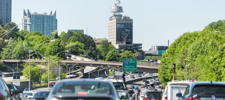 I-85 Interstate 85 highway road street during day in capital Georgia city, cars in traffic, exit sign for Marrietta, Chattanooga, overpass bridges.